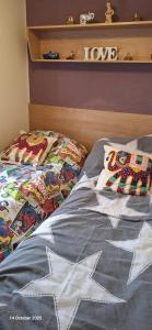 a bed with two pillows on top of it at Heavenly Huts GC056 in Saint Osyth