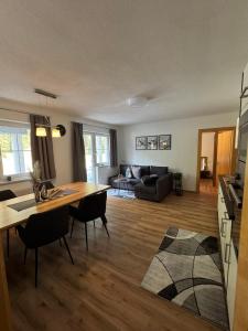 a living room with a table and a couch at Ferienwohnung Höllrigl in Sankt Leonhard im Pitztal +7 photos