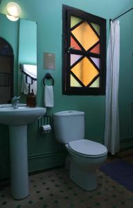 a bathroom with a toilet and a sink and a window at Dar Rass El Maa in Chefchaouene +21 photos