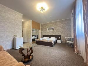 a bedroom with a bed and a table in a room at Delta in Kyiv