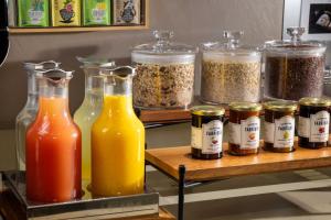 a group of containers of food and spices on a shelf at Hotel Daumesnil-Vincennes in Vincennes