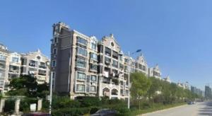 a large apartment building on the side of a street at Jinjiang Inn Select Shanghai Fengxian Baolong Square North Yunhe Road in Fengxian