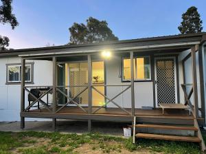 a home with a large screened in porch at The Waratah Escape Nowra in Nowra