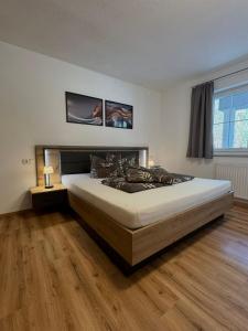 a bedroom with a large bed in a room at Ferienwohnung Höllrigl in Sankt Leonhard im Pitztal