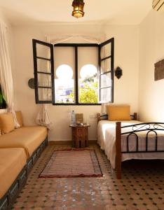 a bedroom with two beds and a window at Dar Rass El Maa in Chefchaouene