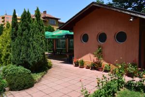 a house with a brick walkway and a patio at Hotel Tintyava 2 in Varshets