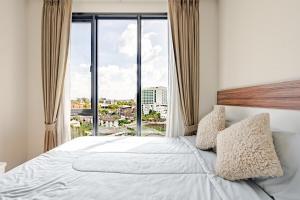 a bedroom with a large bed with a large window at Astra condo - Deluxe room in Chiang Mai +35 photos