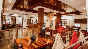 a living room with a couch and a table at Royal Crown Hotel & Spa in Siem Reap