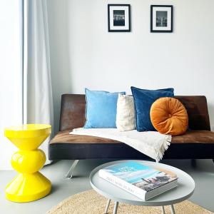 ein Wohnzimmer mit einer Couch und einem Couchtisch in der Unterkunft BNBNRD Stylish Boutique Apartment 45m2 w Panoramic Views - private entrance in Amsterdam