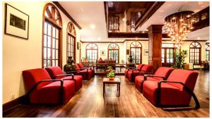 a waiting room with red chairs in a building at Royal Crown Hotel & Spa in Siem Reap