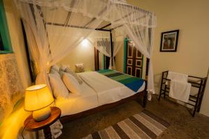 a bedroom with a bed with a canopy at Ella Nine Peaks in Ella