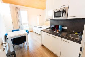 a small kitchen with a sink and a microwave at 214 Salzburg, Studio Apartment, 30m2, 2-4 Personen in Klagenfurt