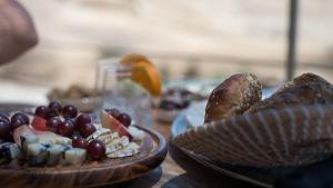 a table topped with plates of fruit and snacks at Amara Escape - Adults only in Zuqim +23 photos