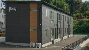 a building with a bunch of windows on it at Opt熊本益城 in Mashiki