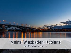 a bridge over a body of water at night at Dahem-Apartments - ruhig Parkplatz Rhein Main Gebiet gut erreichbar - App 1 barrierefrei mit Kamin Garten und Hund - App 2 mit Balkon in Bretzenheim