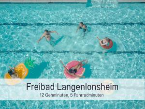 a group of people in a swimming pool at Dahem-Apartments - ruhig Parkplatz Rhein Main Gebiet gut erreichbar - App 1 barrierefrei mit Kamin Garten und Hund - App 2 mit Balkon in Bretzenheim +136 photos