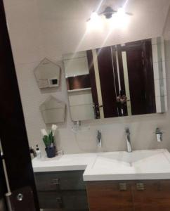 a bathroom with a sink and a large mirror at hotel siyaan in Gūdūr