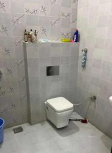a bathroom with a white toilet and a sink at hotel siyaan in Gūdūr
