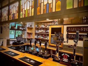 a bar with many bottles of alcohol on a counter at The Charlton Arms in Ludlow