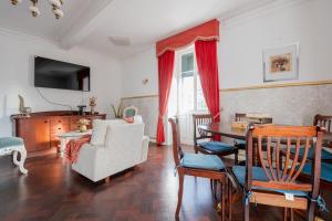 a living room with a table and a couch and a chair at Quinta das Virtudes in Funchal