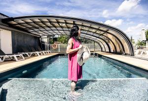 a woman standing in the water in a pool at Lov'nid 'spa & sauna' in Domme