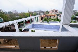 a view from the balcony of a house with a swimming pool at Hotel Harmony Premium in Kutaisi