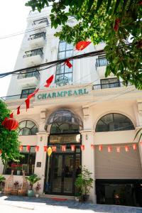 a building with a sign on the front of it at Charmpearl Hotel & Suites in Hanoi