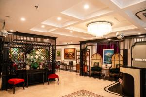a room with a store with a vase of flowers at Charmpearl Hotel & Suites in Hanoi +92 photos