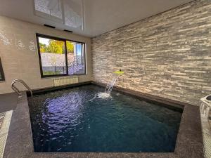 a swimming pool with a water fountain in a room at White Family House in Tsaghkadzor
