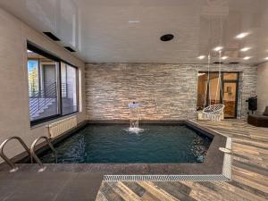 a swimming pool in the middle of a house at White Family House in Tsaghkadzor