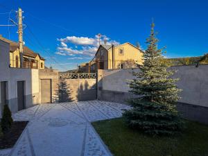 a christmas tree in the yard of a house at White Family House in Tsaghkadzor