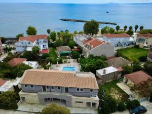 an aerial view of a houses and the ocean at Notos Luxury Studios in Katelios