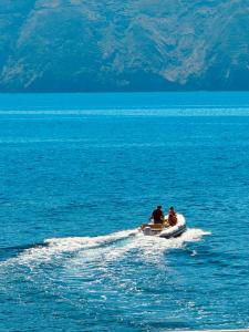 two people in a boat in the water at Halgoduria in Santa Marina Salina +55 photos