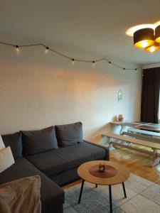 a living room with a couch and a table at Kaksio lähellä keskustaa in Iisalmi