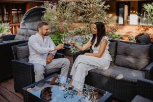 a man and a woman sitting on a couch at Hotel Frýdl in Prague