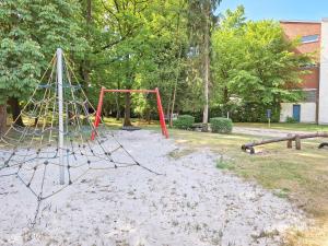 a playground with a swing set in a park at Camping Het Veen in Brecht