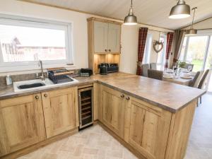 a kitchen with a sink and a counter top at Curlew Lodge in Carnforth