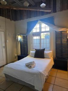 a bedroom with a bed with a stuffed animal on it at Strand Hotel in Strand