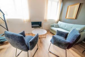 a living room with blue chairs and a couch at The Little Dumont - 2-person Apartment - Croix-Rousse in Lyon