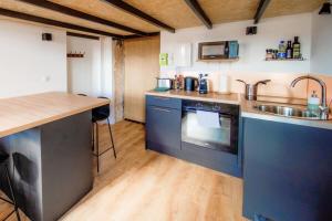 a kitchen with a sink and a stove top oven at The Little Dumont - 2-person Apartment - Croix-Rousse in Lyon