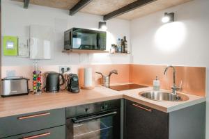 a kitchen with a sink and a microwave at The Little Dumont - 2-person Apartment - Croix-Rousse in Lyon +22 photos