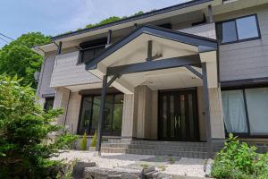 a house with a blue roof at BROOK COTTAGE MINAKAMI in Minakami