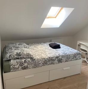 a bed in a room with a window at ღ Ordemique - Coeur de ville 7 chambres, Wifi fibre in Douai