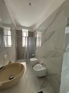a bathroom with a tub and a sink and a toilet at La casa dei sogni in Torre del Greco
