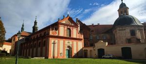 a large brick building with a domed building with a car parked in front at Ubytovani Sarka in Čistá