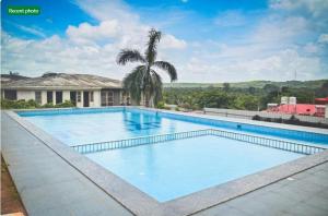 a large swimming pool in front of a house at Villa with Pool at Sea Horizon Luxurious Villas in Mandrem
