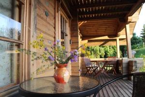 a vase sitting on top of a table on a porch at Kangru Holiday Home in Vanamõisa