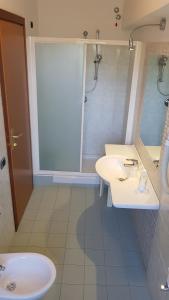 a bathroom with a white sink and a shower at Riviera Hotel in Enna