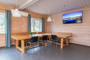 a dining room with a wooden table and chairs at Anupro Villa in Trakai
