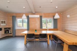 a dining room with a wooden table and chairs at Anupro Villa in Trakai